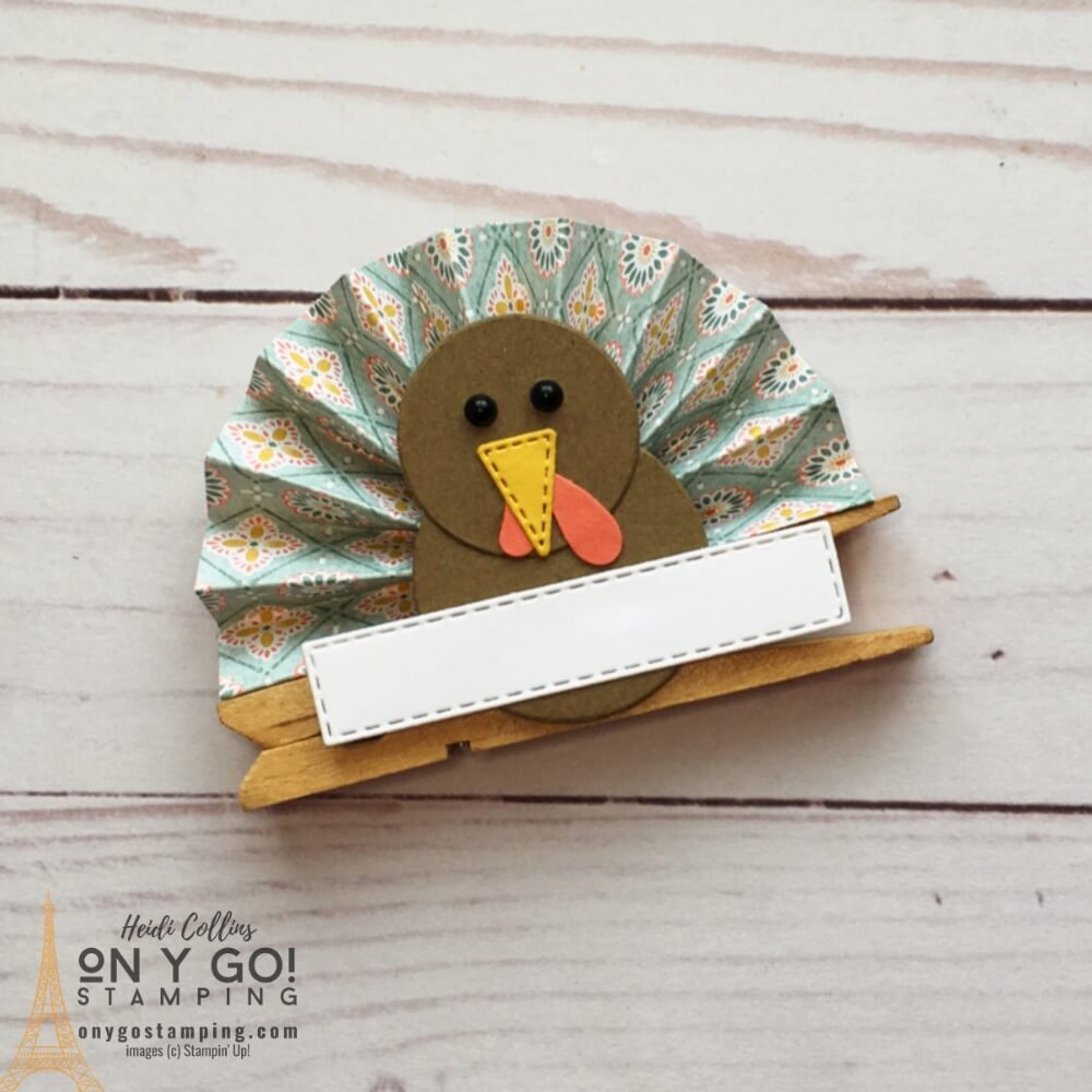 DIY Thanksgiving Table Decoration. Create this fun little clothespin turkey with a little patterned paper and cardstock. Use it as a table place card or just add a Thanksgiving sentiment.