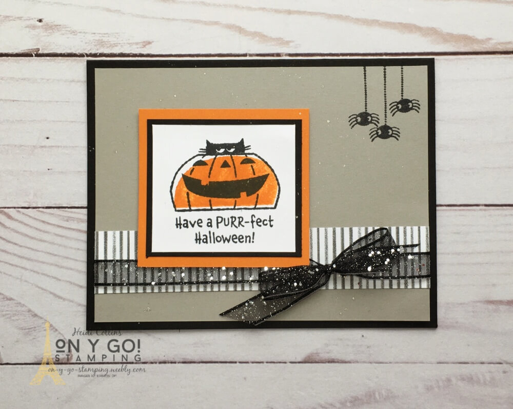 Halloween card design with a cute cat peeking out of a jack o' lantern and three little spiders looking on. This fun card design is made with the Clever Cats stamp set.