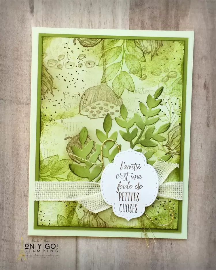 The Enjoy the Moment and Forever Fern stamp sets on a card design using the collage card making technique. The stamped images are layered with blended ink to create a collage background. 
