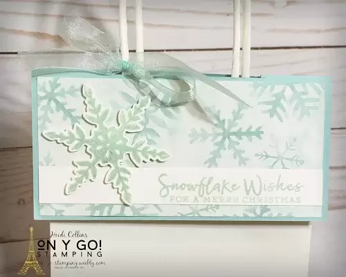 Christmas gift bag topper using the Snowflake Wishes stamp set and Snowflake Splendor patterned paper from Stampin' Up! This quick and easy gift bag topper turns a plain dollar store gift bag into a handmade beauty and it hides the gift inside!