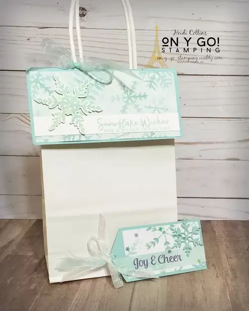 Holiday gift bag and tag using the Snowflake Splendor patterned paper and Snowflake Wishes stamp set from Stampin' Up! This quick and easy topper for a dollar store gift bag cover the gift inside the bag without having to use tissue paper. 
