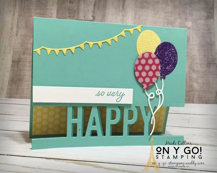 Fun birthday card idea using the So Much Happy stamp set and dies from Stampin' Up! This card has a cut out greeting on the front to reveal a layer of patterned paper below.